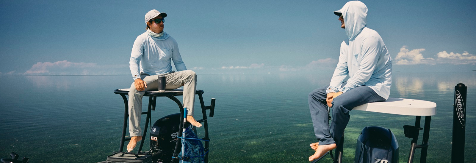 https://freeflyapparel.com/cdn/shop/articles/Two_men_sitting_on_top_of_their_boats_wearing_sun_protection_hoodies_and_neck_gaiters.png?v=1692898285