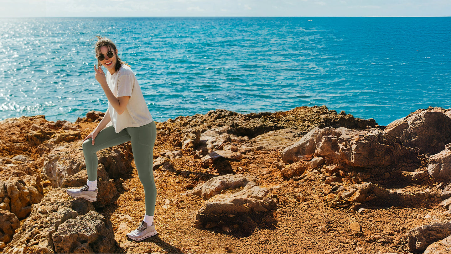 Person standing on rocky terrain by the ocean